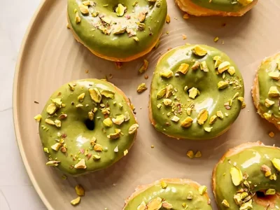 donuts covered in pistachio paste which is an example of pistachio paste industrial use